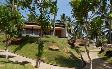 Amanwella's manicured gardens with pavilions nestled amongst mature trees and lush lawns.