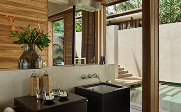 Bathroom vanity with wooden panelling and large mirror at Amanwella, Sri Lanka.