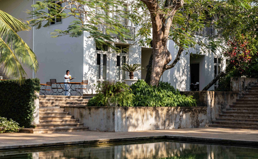 Ben Richards photograph of a reflective pond with a gnarled tree and colonial-era building at Amangalla, February 2022.