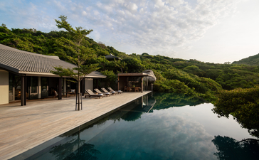 Four-bedroom ocean pool family residence terrace at Amanoi, Vietnam, with swimming pool overlooking forested hillside.