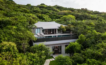 Aerial view of an ocean pool villa at Amanoi, Vietnam, surrounded by lush tropical vegetation.
