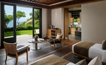 Principal bedroom at Amanoi with ocean views, sitting area, and direct access to tropical gardens.
