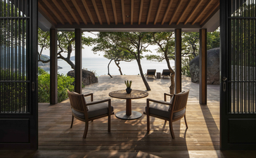 Ocean Pavilion at Amanoi with wooden deck, lounge chairs, and coastal views through open archways.