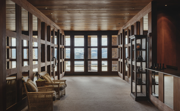 Library with floor-to-ceiling bookshelves and seating at Amangani.