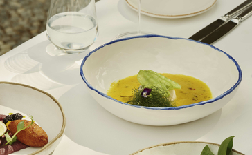 Turkish dining at Amanruya with fresh seafood and vegetable dishes elegantly plated on white tableware.