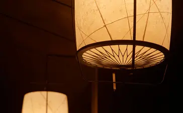 Lanterns illuminated at dusk in the Living Pavilion at Aman Kyoto resort.