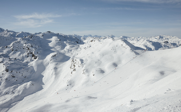 Snow-covered Alpine peaks surrounding Aman Le Mélézin in the French Alps.