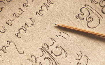 A student writes Aksara Bali script during a calligraphy class at Amandari, Indonesia.