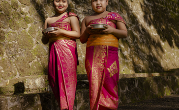 Two young dancers in traditional pink silk costumes at Amandari, Indonesia.