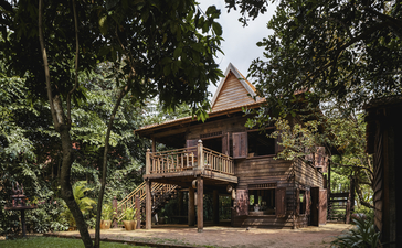 Wooden villa nestled amongst tropical foliage at Amansara, Cambodia.