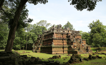 Amansara's temple ruins stand amongst verdant grounds and mature trees in Cambodia.