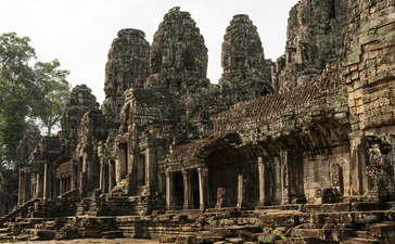 Ancient stone temple with towering carved pillars and weathered facades at Amansara.
