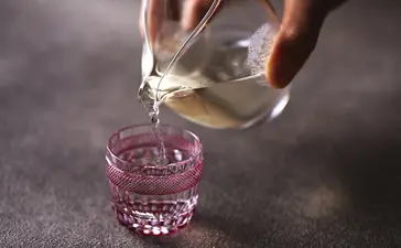 Water being poured into a glass at Aman Tokyo.