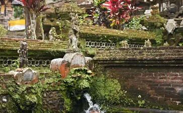 Guest participating in Melukat water blessing ceremony at Amandari, Indonesia.