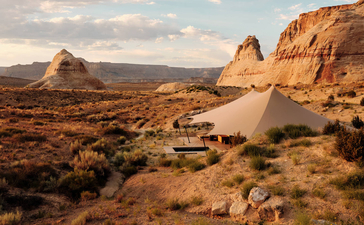 Desert landscape at Amangiri with dramatic rock formations and sandy terrain under soft light.