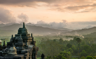 Temple overlooking verdant volcanic landscape at Amanjiwo resort, Borobudur.