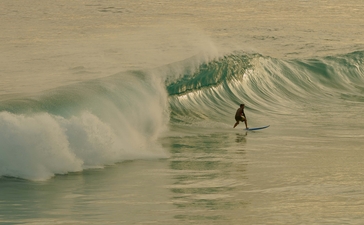 Surfer riding a wave at Amanera resort, Dominican Republic.