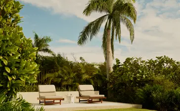 Hill Casita terrace with loungers overlooking lush tropical gardens at Amanera, Dominican Republic.