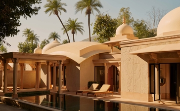 Pool pavilion at Amanbagh with terracotta walls and dome architecture overlooking the grounds.