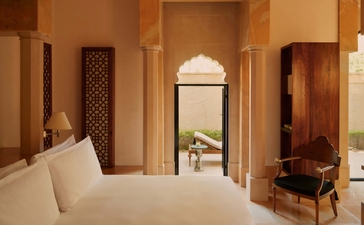 Courtyard Haveli Suite at Amanbagh with bed, archway, and traditional Indian architectural details.