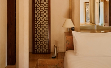 Courtyard Haveli Suite at Amanbagh with carved wooden screen, warm stone walls, and traditional architectural details.