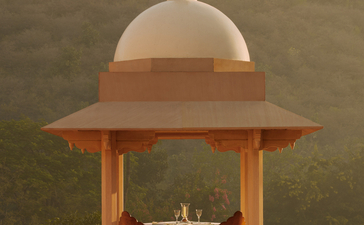 Amanbagh's main building exterior featuring a domed pavilion with terracotta columns and cream dome.