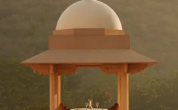 Amanbagh's main building exterior featuring a domed pavilion with terracotta columns and cream dome.