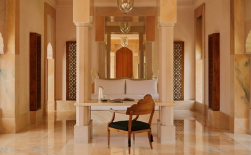 Terrace Haveli Suite at Amanbagh with symmetrical corridors, marble flooring, and central seating area.