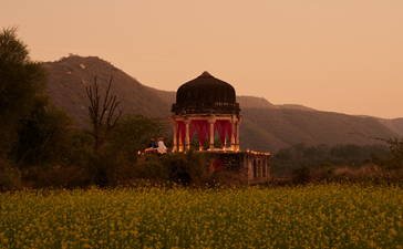 Chhatri pavilion lit at dusk for dinner, Amanbagh.
