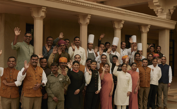 Group of hotel guests gathered in the courtyard at Amanbagh, Rajasthan.