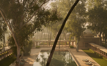 Courtyard view at Amanbagh with curved tree branch framing gardens and water features below.
