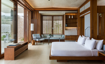 Two-bedroom Casa bedroom at Amanera, Dominican Republic, with wooden furnishings and garden views.