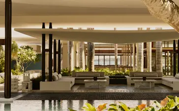 Entrance at Amanera resort, Dominican Republic, with modern pavilion, planted gardens and ambient lighting.
