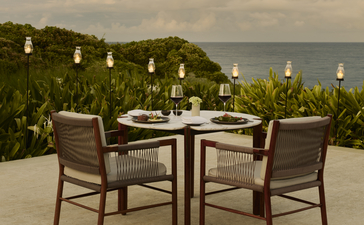 Private dining setup at Amanera with ocean views and candlelit tables.