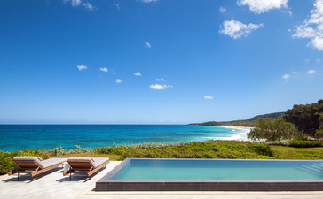 Amanera casita pool overlooking a curved sandy beach and turquoise waters.