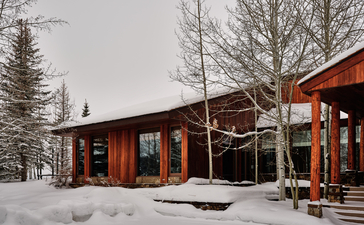 Wapiti Home at Amangani with wooden exterior and snow-covered grounds in Jackson Hole.