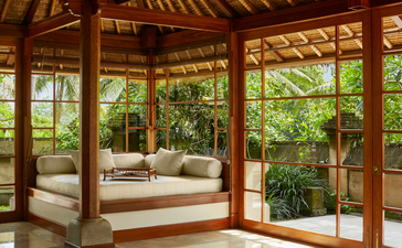 Duplex Pool Suite living area at Amandari with wooden pavilion, daybed, and views of tropical gardens.