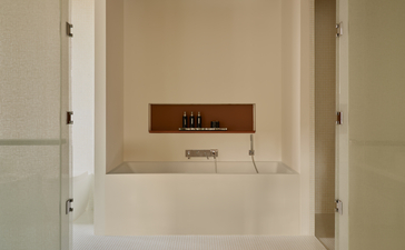 Grand Canal Suite bathroom at Aman Venice, featuring a minimalist vanity with wooden accents and neutral tones.