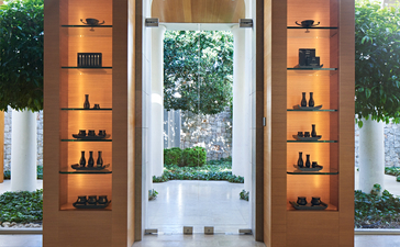 Aman Skincare display with illuminated shelving in the spa waiting room at Amanzoe resort.