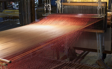 Silk threads on traditional weaving loom at Bevilacqua, Aman Venice.