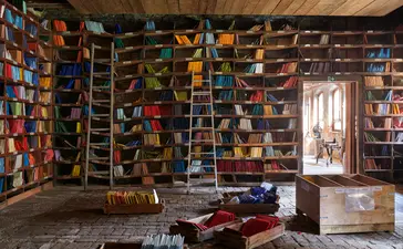 Orsoni mosaic studio in Venice, walls lined with colourful glass tiles and tools scattered across the workspace.