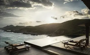 One-bedroom ocean pool residence at Amanoi with views towards forested coastline and moored boats.