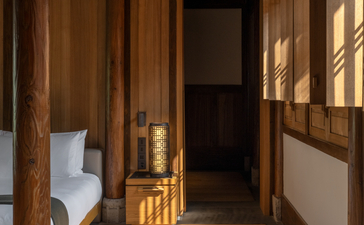 Wooden corridor at Amanyangyun with traditional architectural details and natural light streaming through windows.