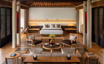 Brazilian pavilion-inspired bedroom at Amanoi with teak furnishings and coastal views.