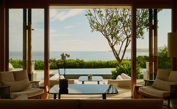 Casita at Amanera resort with open doors framing a plunge pool and tropical landscape beyond.