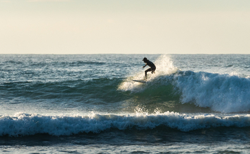 Surfer riding a wave at Amanwella, Sri Lanka.