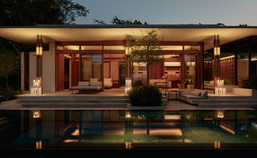Amanera resort's evening exterior with illuminated pavilions reflected in still water at dusk.