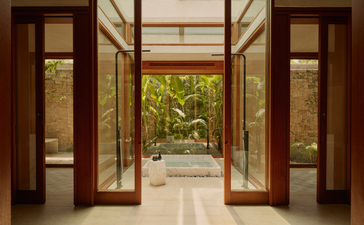 Two-bedroom casa at Amanera with wooden doors opening onto tropical gardens.