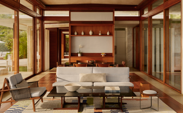 Two-bedroom casa living area at Amanera with wooden beams, neutral furnishings and natural light.