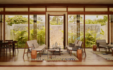 Two-bedroom casa lounge at Amanera with floor-to-ceiling windows overlooking gardens.